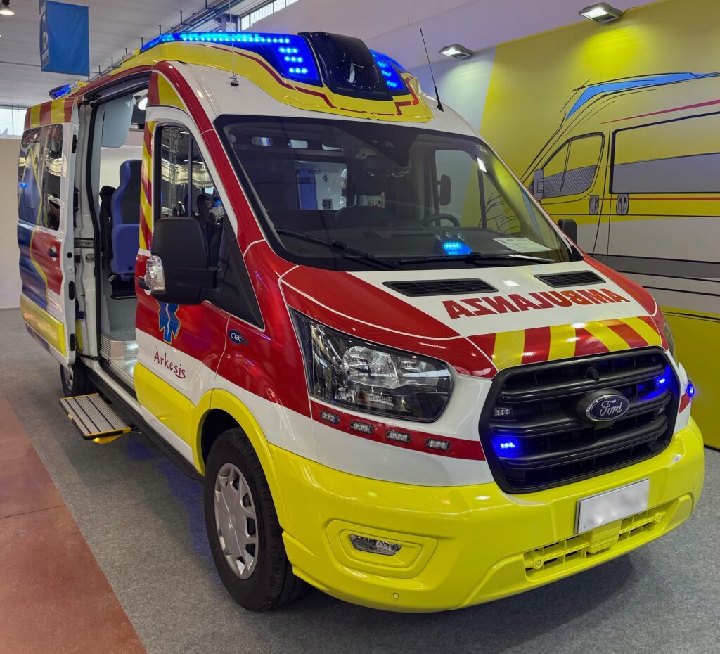 Custom spoiler with integrated LED lighting on a yellow ambulance for improved aerodynamics